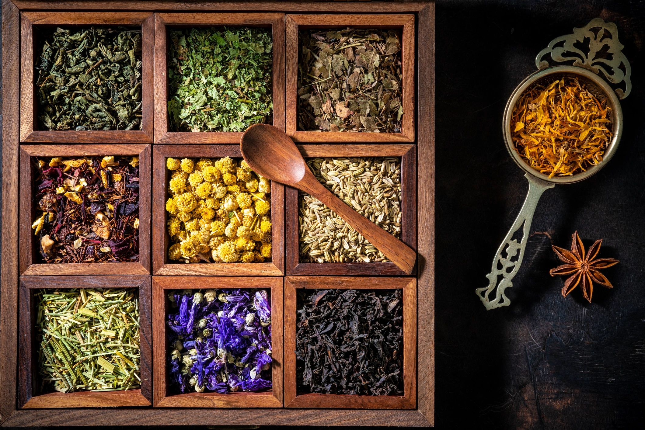 Wooden box filled with loose-leaf teas and herbs